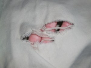 Closeup of hole in bottom with fingers so you can see